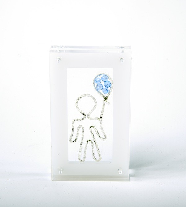 Handmade sterling silver lucky boy charm in plexiglass.