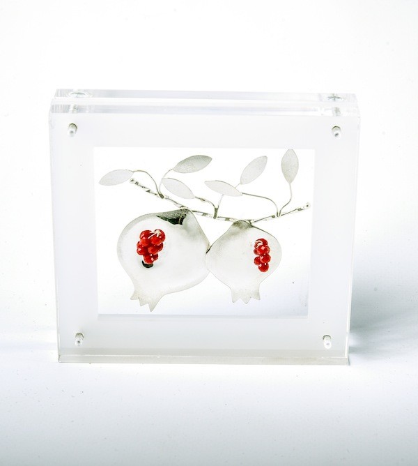Handmade sterling silver pomegranates in plexiglass.